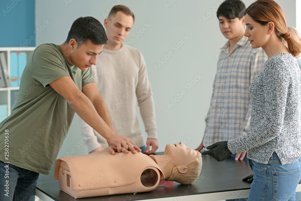 People learning to perform CPR at first aid training course People learning to perform CPR at first aid training course