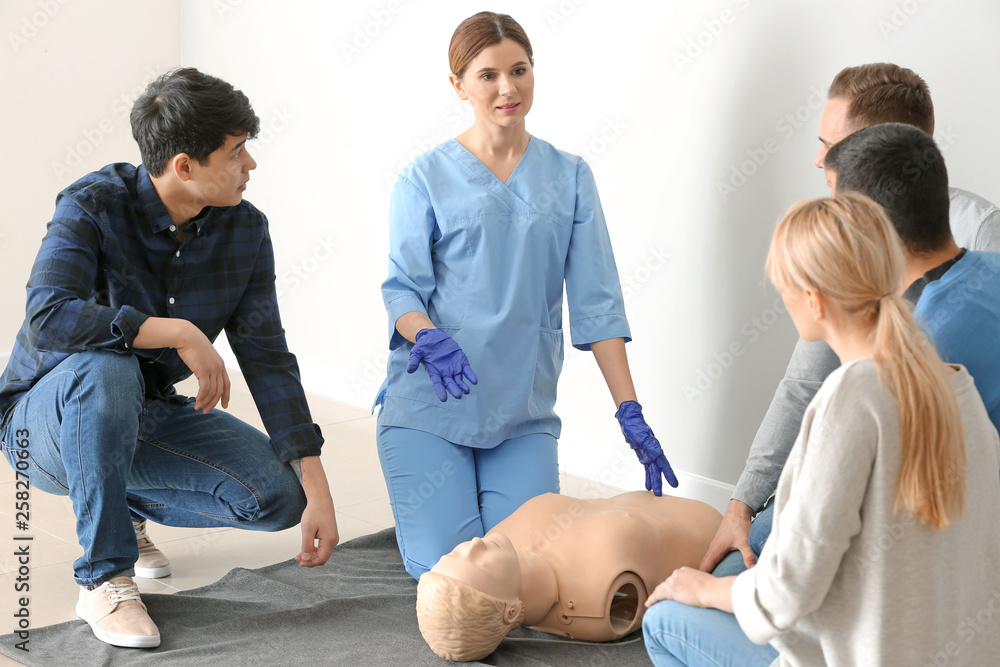 Obraz premium Group of people with instructor at first aid training course