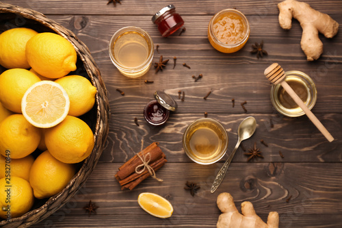 Tasty drink with lemon, ginger and honey on wooden table