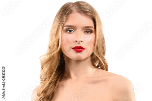 Beautiful young woman with bright makeup on light background