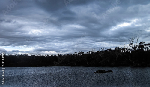 A thick and distinct layer of clouds hangs over the Walls of Jerusalem National Park in Tasmania. photo