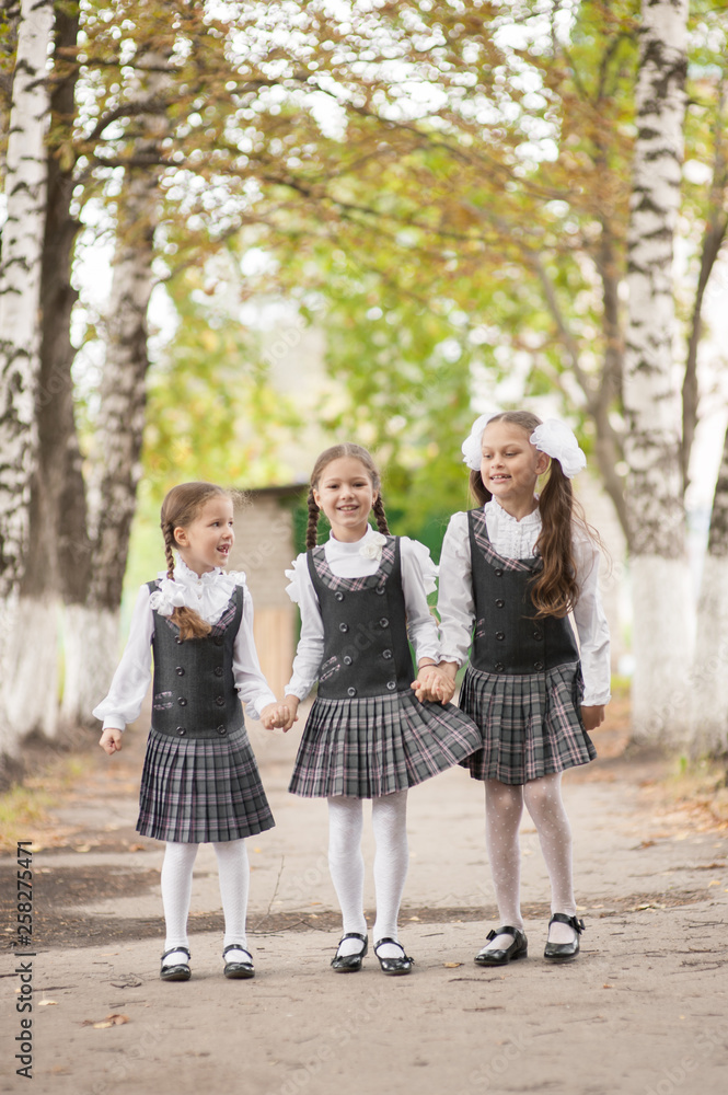custom made wallpaper toronto digitalSmiling young children in a school uniform jumping on the road in the park at the day time.
