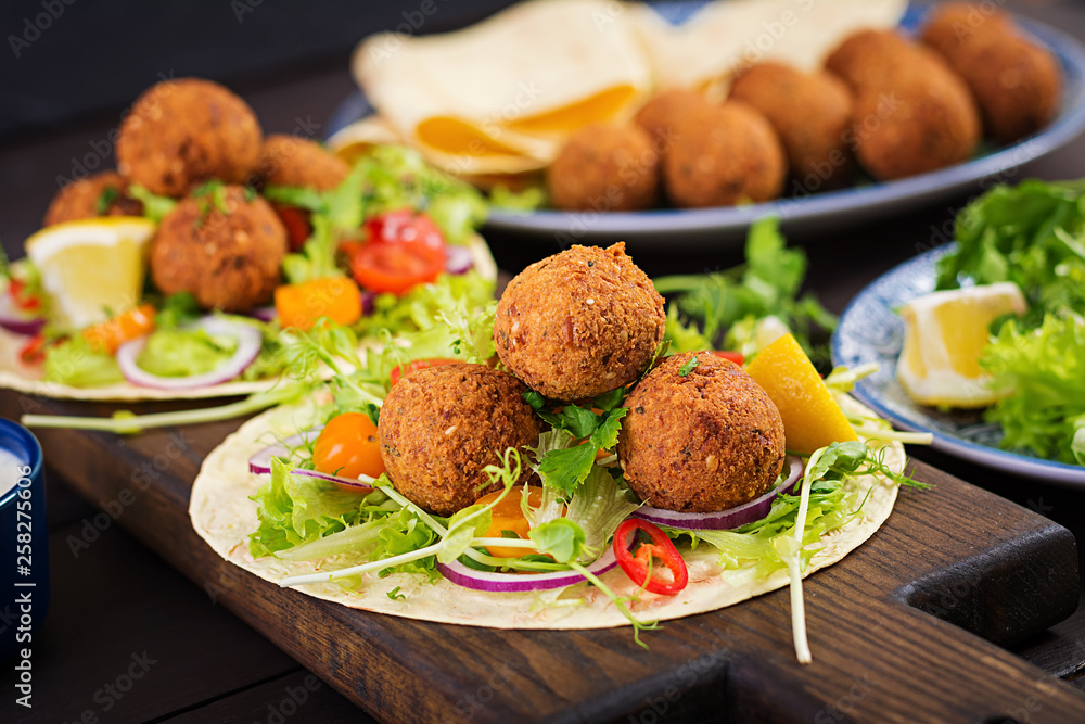 Tortilla wrap with falafel and fresh salad. Vegan tacos. Vegetarian healthy food. Tortilla wrap with falafel and fresh salad. Vegan tacos. Vegetarian healthy food.