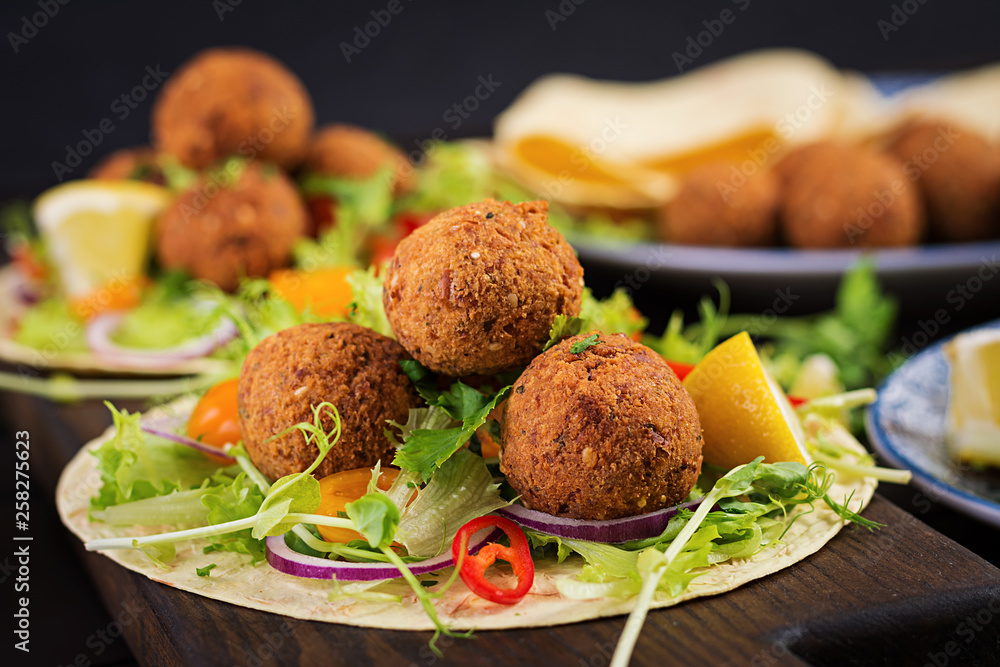 Tortilla wrap with falafel and fresh salad. Vegan tacos. Vegetarian healthy food. Tortilla wrap with falafel and fresh salad. Vegan tacos. Vegetarian healthy food.