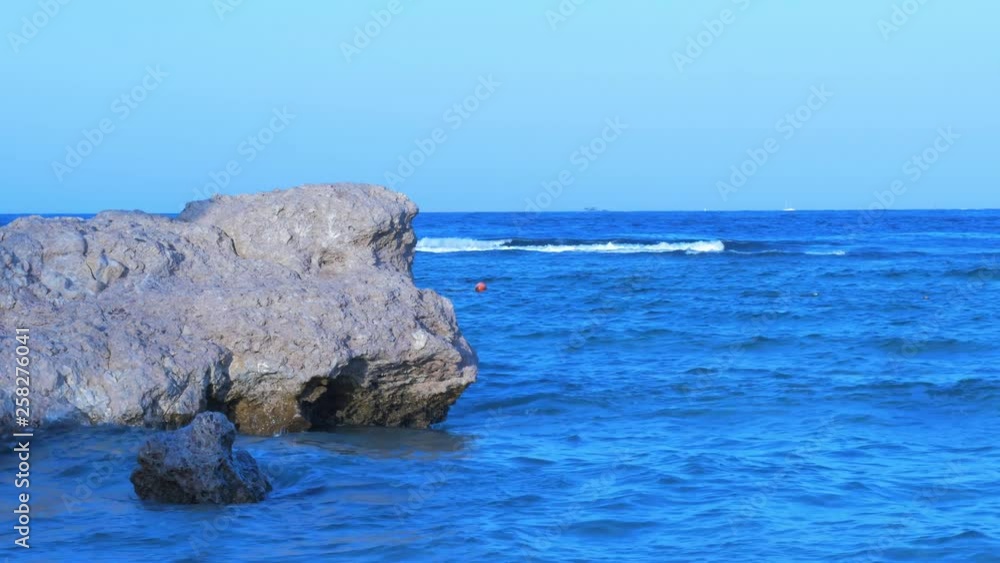 Red Sea waves hitting the coastline rocks at Sharm El Sheikh in sunny afternoon, medium shot Red Sea waves hitting the coastline rocks at Sharm El Sheikh in sunny afternoon, medium shot