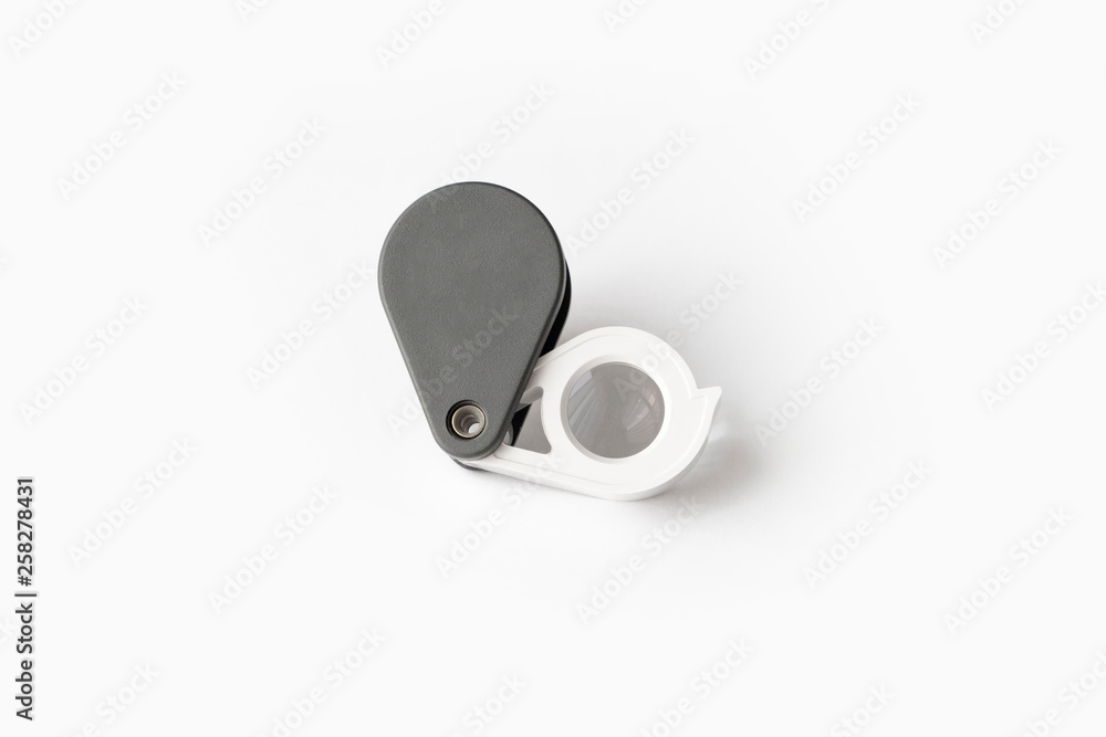 Magnifying glass for diamonds or see the amulet Isolated on a White Background. Magnifying glass for diamonds or see the amulet Isolated on a White Background.