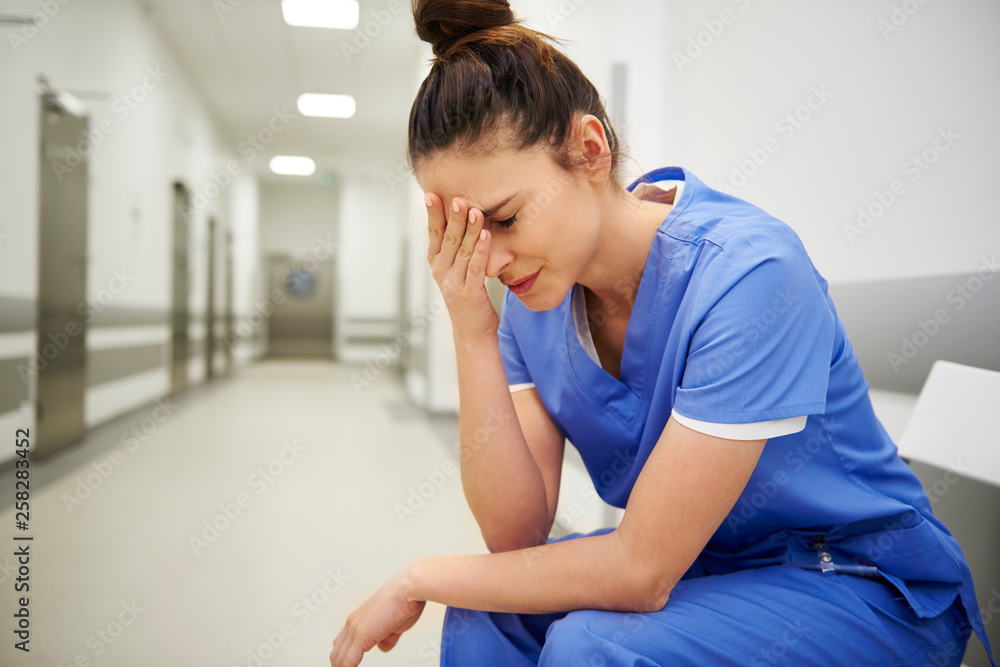 Female nurse suffering from headache Female nurse suffering from headache