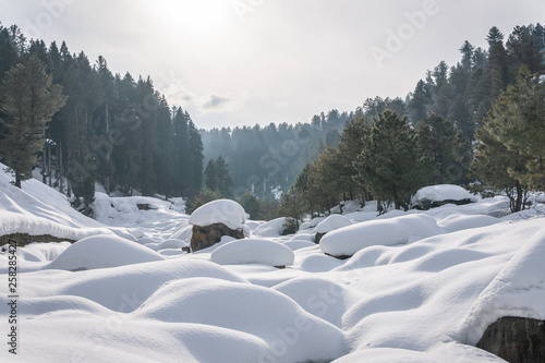 Boulders and rocks covered with snow in a mountain valley landscape