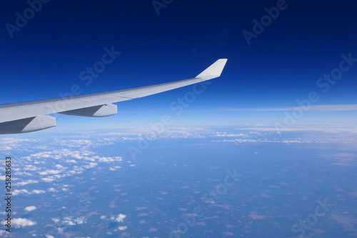 A Airplane in the air, with a clear sky in the background