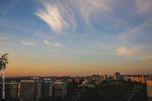 Sunset sky over the city. Beautiful shades and colours of clouds. © Vadym