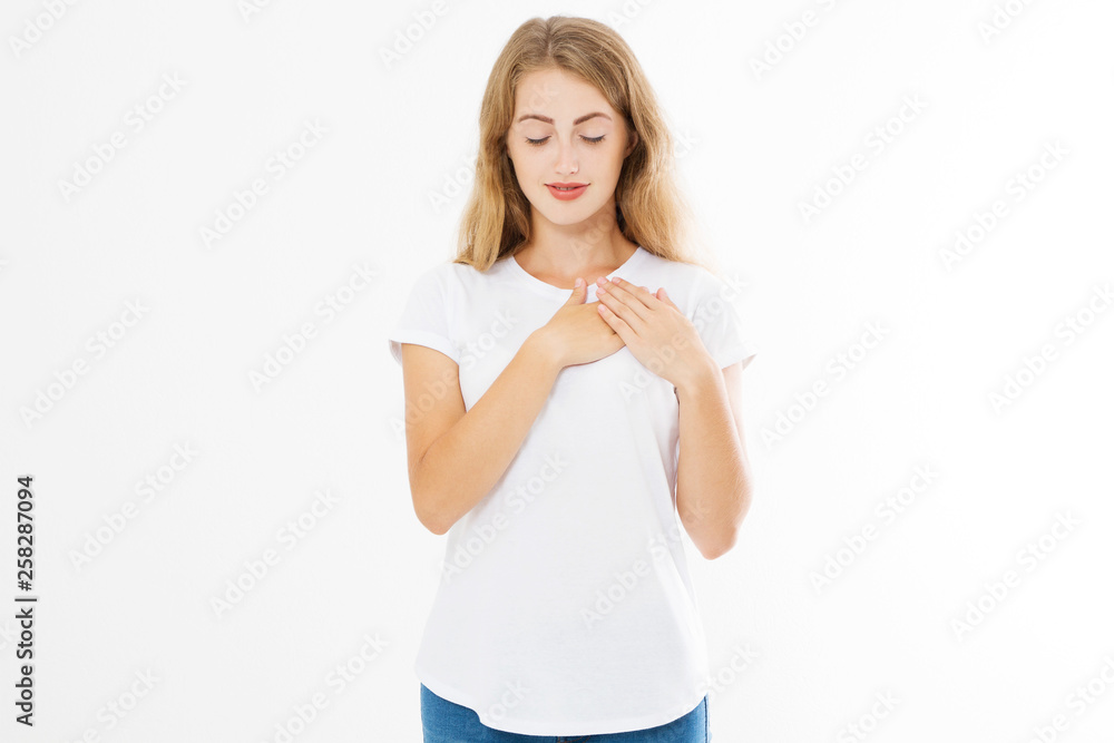 Girl touching her heart. Healthy life style living. Love romance and body language. Smiling happy woman face and template white t shirt with copy space isolated on white background. Summer time Girl touching her heart. Healthy life style living. Love romance and body language. Smiling happy woman face and template white t shirt with copy space isolated on white background. Summer time