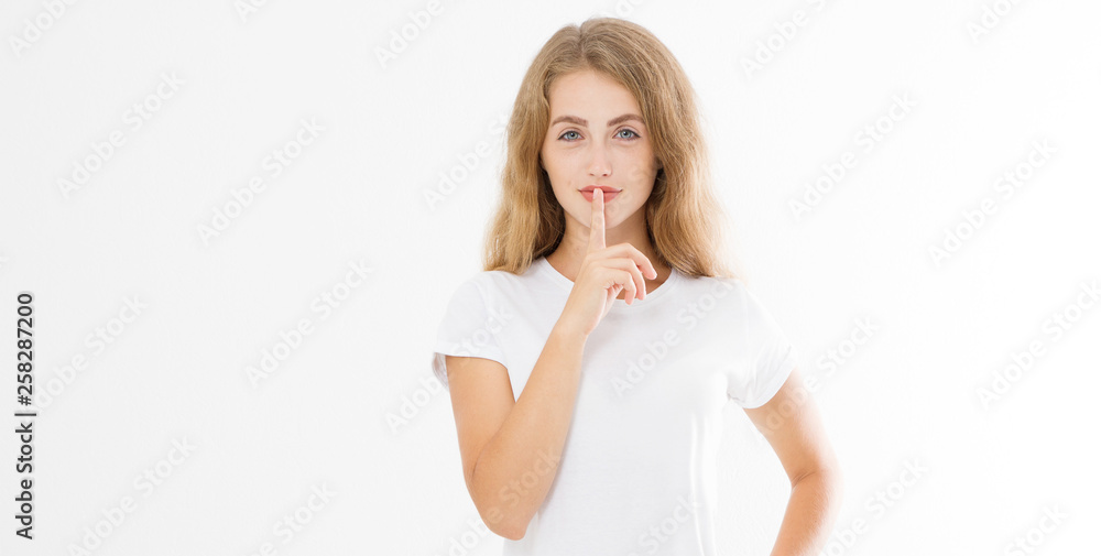 Shhh sign. Young woman showing shh gesture to keep a silent. Girl in template white t shirt keep a secret. Quiet place and silence time. Copy space. Banner Shhh sign. Young woman showing shh gesture to keep a silent. Girl in template white t shirt keep a secret. Quiet place and silence time. Copy space. Banner