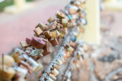 Lock for couple make a promise to love forever, master keys hanging on the rails of bridge, the sign of love and romantic affection as a landmark. Symbolic love locks hang along.