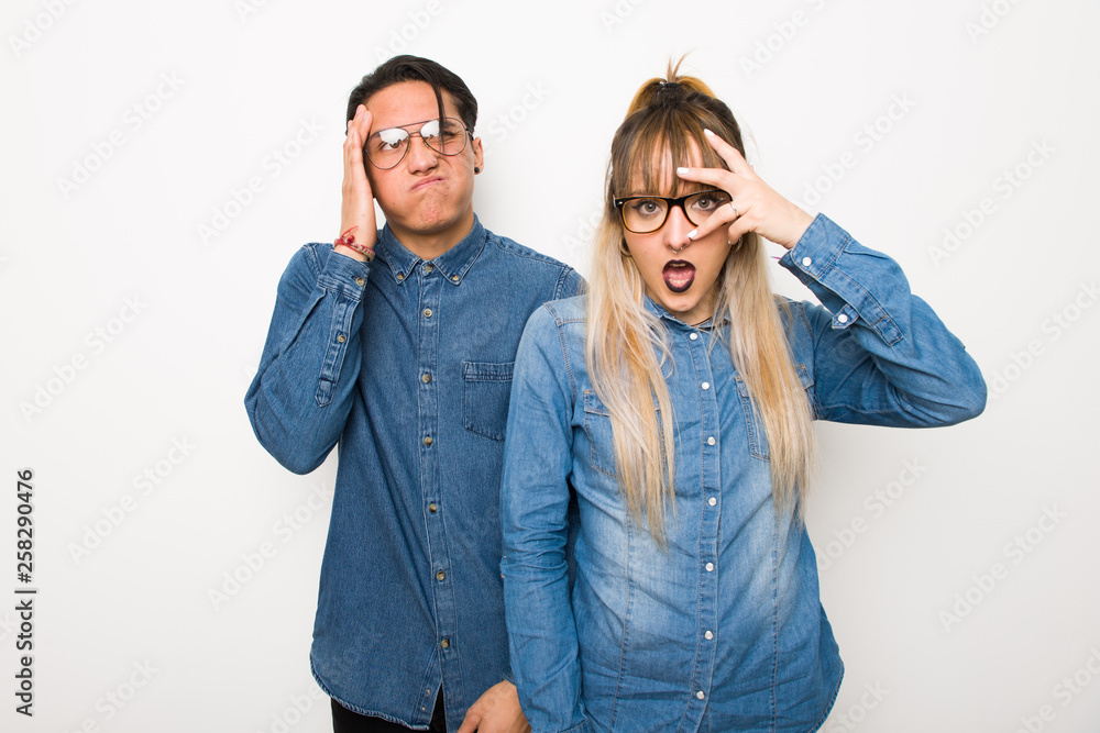 Young couple with glasses with surprise and shocked facial expression Young couple with glasses with surprise and shocked facial expression