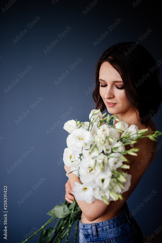 Beautiful girl with a bouquet flowers.