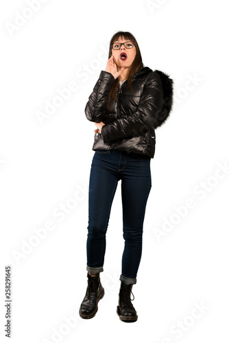 Full-length shot of Woman with glasses surprised and shocked while looking right