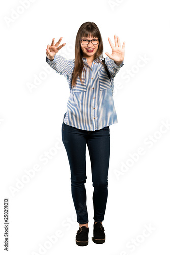 Full-length shot of Woman with glasses counting eight with fingers