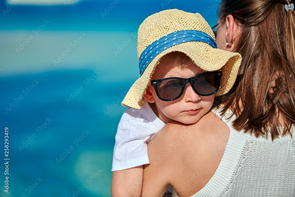 Toddler boy on beach with mother Toddler boy on beach with mother
