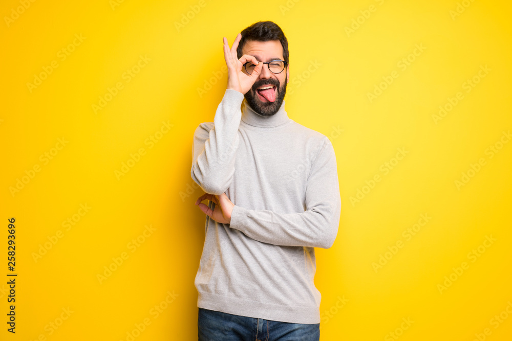 Man with beard and turtleneck makes funny and crazy face emotion Man with beard and turtleneck makes funny and crazy face emotion