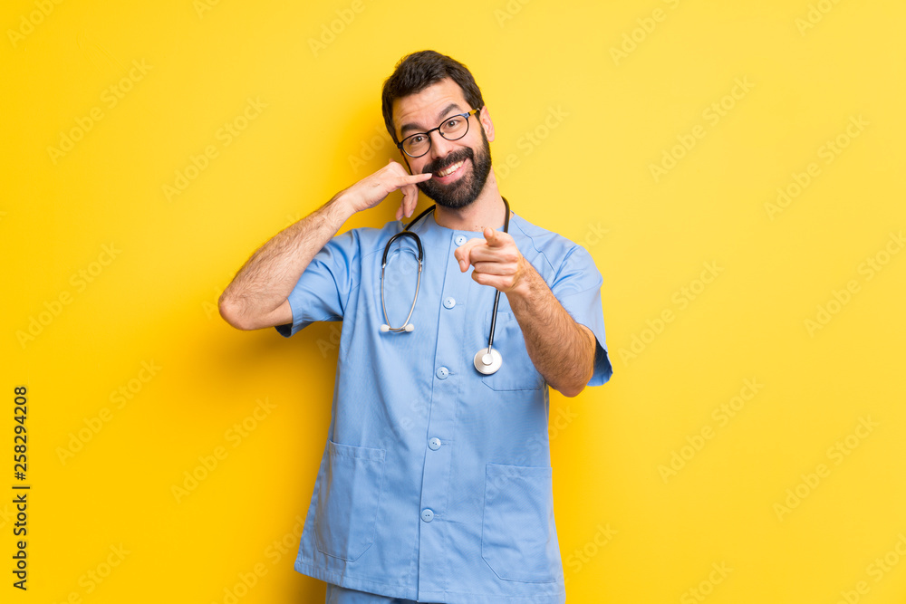 Surgeon doctor man making phone gesture and pointing front Surgeon doctor man making phone gesture and pointing front