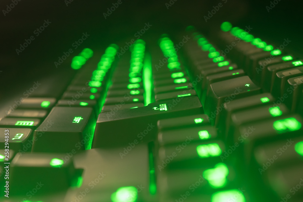 Green gaming keyboard. Focus on enter key.