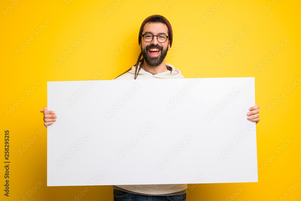 Hippie man with dreadlocks holding a placard for insert a concept Hippie man with dreadlocks holding a placard for insert a concept