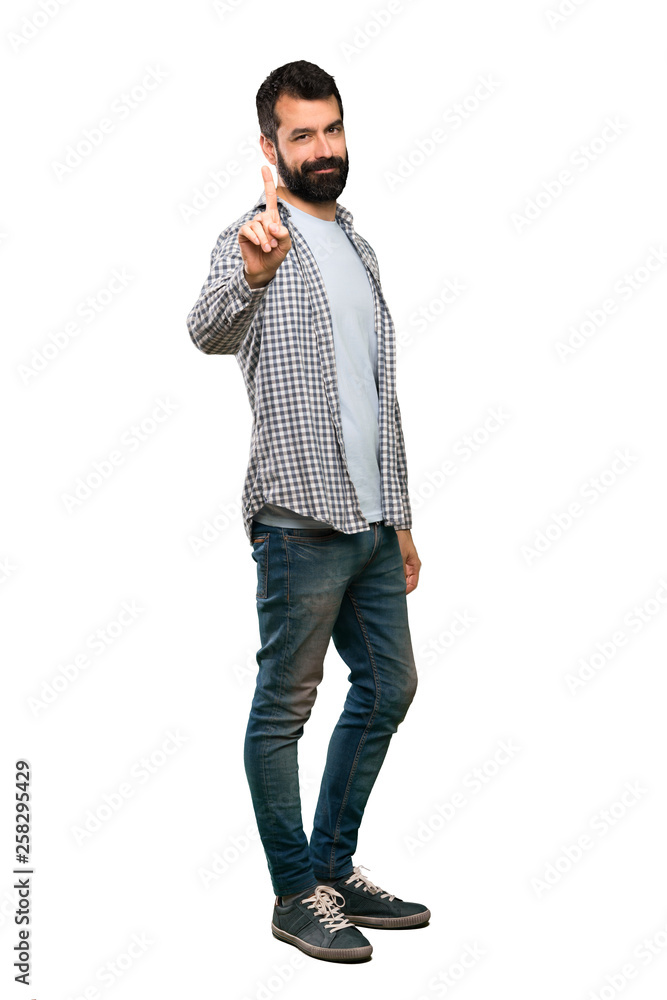 Handsome man with beard showing and lifting a finger over isolated white background Handsome man with beard showing and lifting a finger over isolated white background