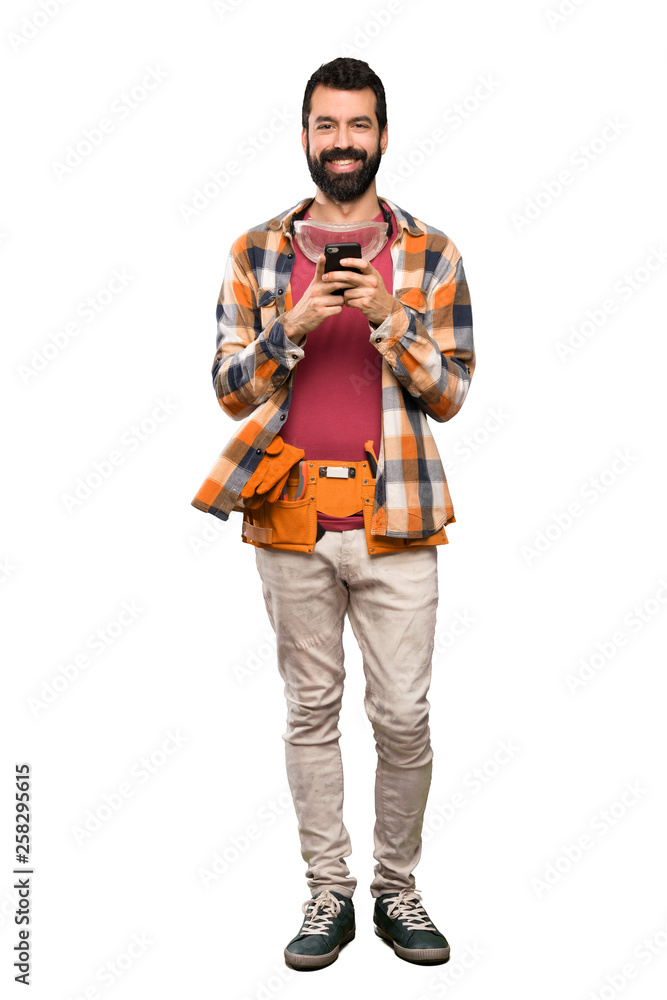 Craftsmen man sending a message with the mobile over isolated white background Craftsmen man sending a message with the mobile over isolated white background