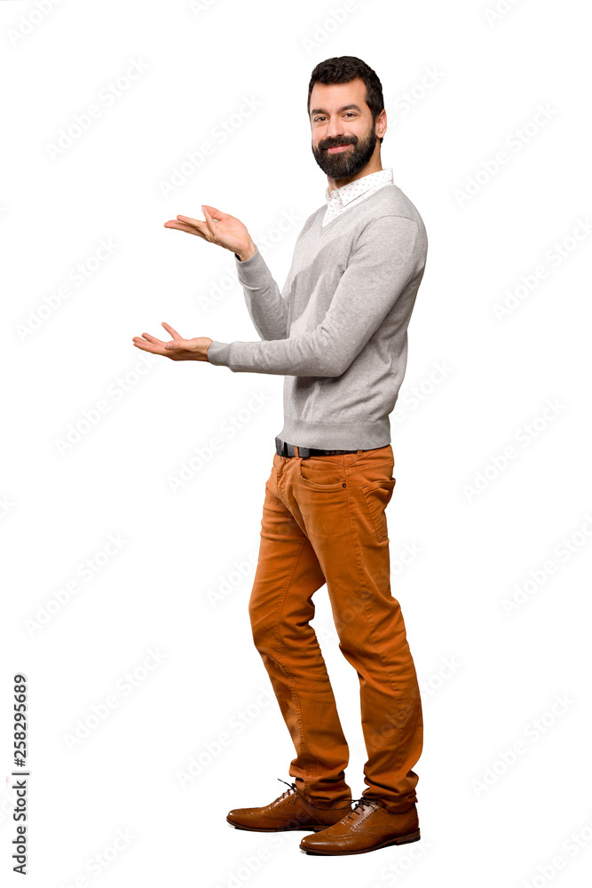 Handsome man extending hands to the side for inviting to come over isolated white background Handsome man extending hands to the side for inviting to come over isolated white background