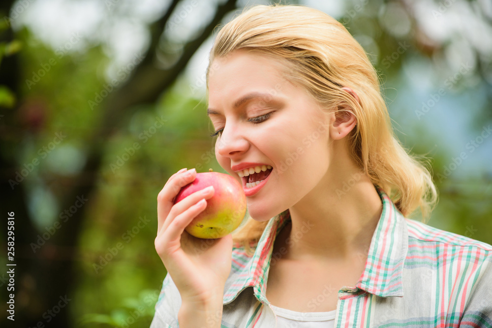Local crops concept. Healthy lifestyle. Eat fruits every day. Woman hold apple green garden background. Organic natural product. Girl gather apple harvest in own garden. Farmer girl hold apple Local crops concept. Healthy lifestyle. Eat fruits every day. Woman hold apple green garden background. Organic natural product. Girl gather apple harvest in own garden. Farmer girl hold apple