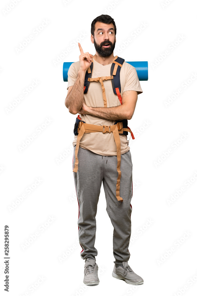Hiker man thinking an idea pointing the finger up over isolated white background Hiker man thinking an idea pointing the finger up over isolated white background