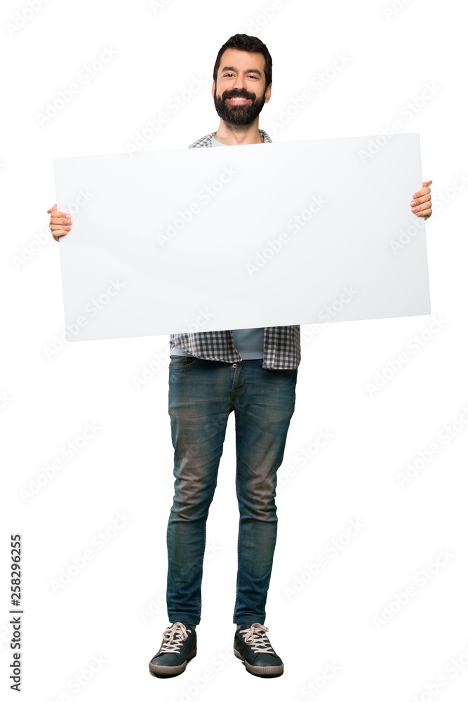 Happy Handsome man with beard holding an empty placard Happy Handsome man with beard holding an empty placard