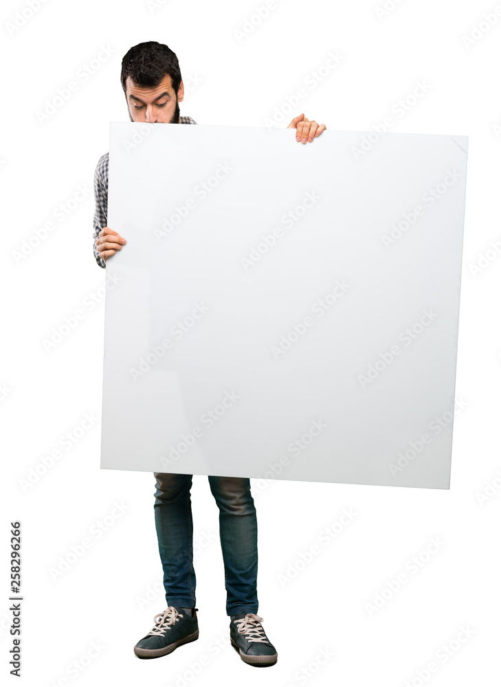 Handsome man with beard holding an empty placard Handsome man with beard holding an empty placard