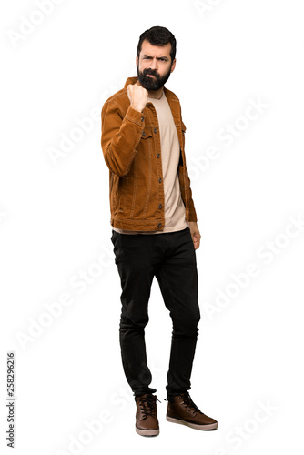 Handsome man with beard with angry gesture over isolated white background © luismolinero