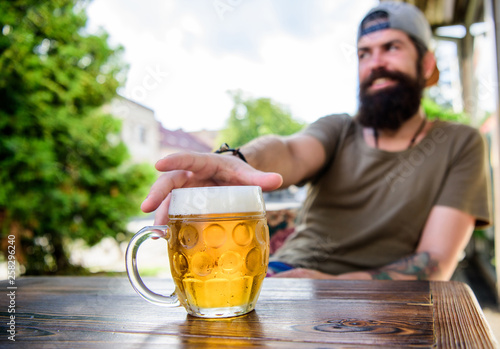 He has the bad habit of drinking too much beer. Chilled beer mug on table. Bearded man drinking beer in bar. Brutal man relax drinking alcohol in beer restaurant. Hipster enjoy drinking party in pub