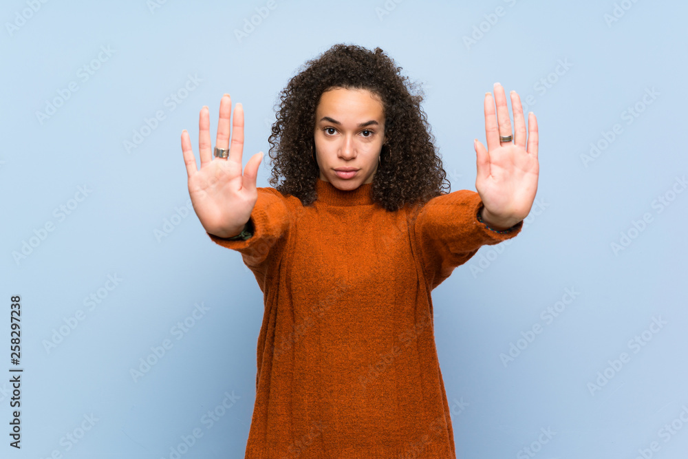 Dominican woman with curly hair making stop gesture and disappointed Dominican woman with curly hair making stop gesture and disappointed