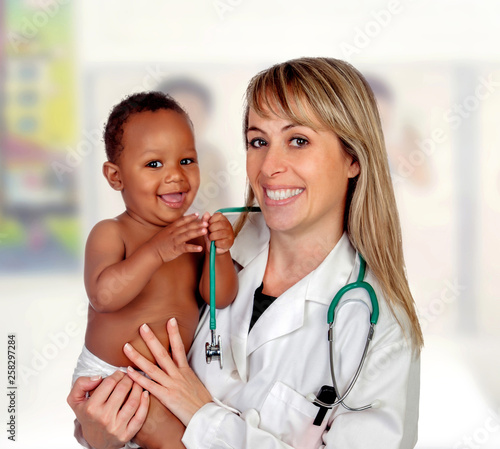 Pretty blonde pediatrician with a beautiful African American baby in arms