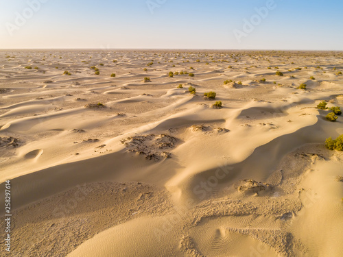 Sundown in desert.Big sand dunes panorama. Desert or beach sand textured background. 