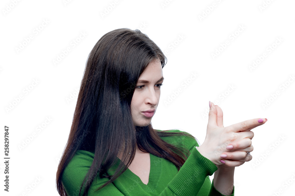 Young brunette woman showing handgun gesture. She wearing green blouse. Studio portrait isolated on white with high resolution. Young brunette woman showing handgun gesture. She wearing green blouse. Studio portrait isolated on white with high resolution.