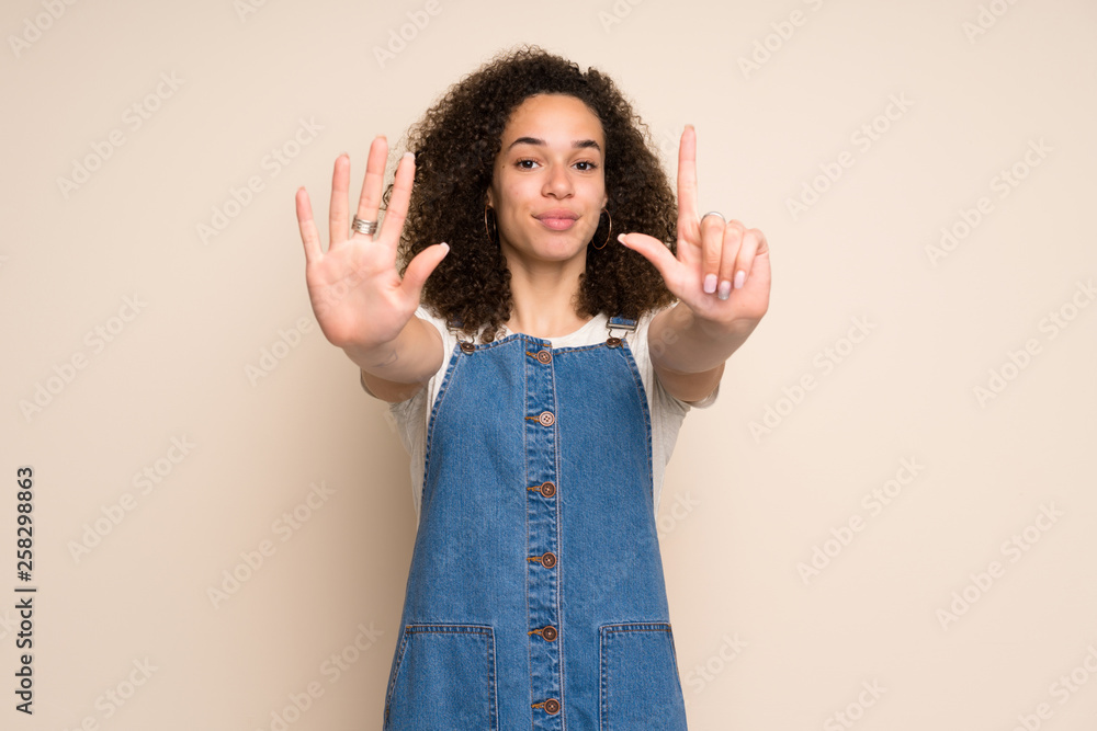 Dominican woman with overalls counting seven with fingers Dominican woman with overalls counting seven with fingers