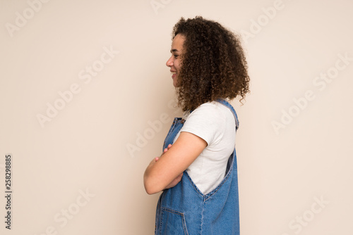 Dominican woman with overalls in lateral position