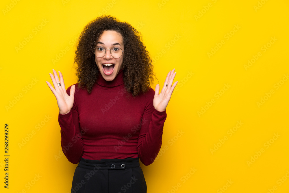 Dominican woman with turtleneck sweater with surprise and shocked facial expression Dominican woman with turtleneck sweater with surprise and shocked facial expression