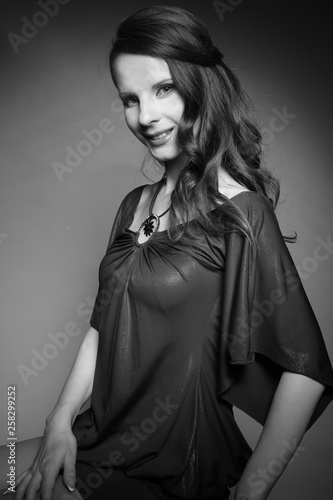 Portrait of young beautiful woman in dress with her hair, girl smiling