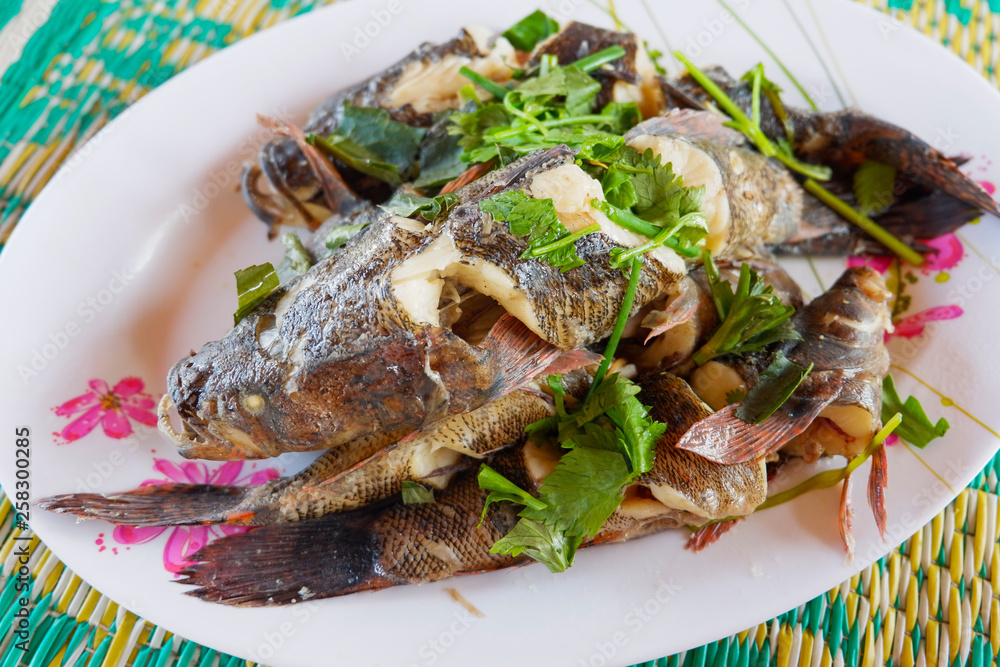 Cooked goby fish steamed with vegetable and herb on plate Stock Photo ...