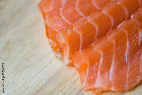 Fresh salmon fillet on cutting board / Close up of raw salmon fish seafood