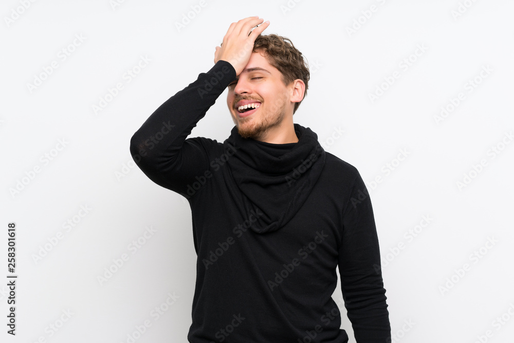 Blonde man over isolated white wall has realized something and intending the solution Blonde man over isolated white wall has realized something and intending the solution