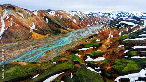 Aerial view landscape of Landmannalaugar surreal nature scenery in highland of Iceland, Europe. Beautiful colorful snow mountain terrain famous for summer trekking adventure and outdoor walking. photo