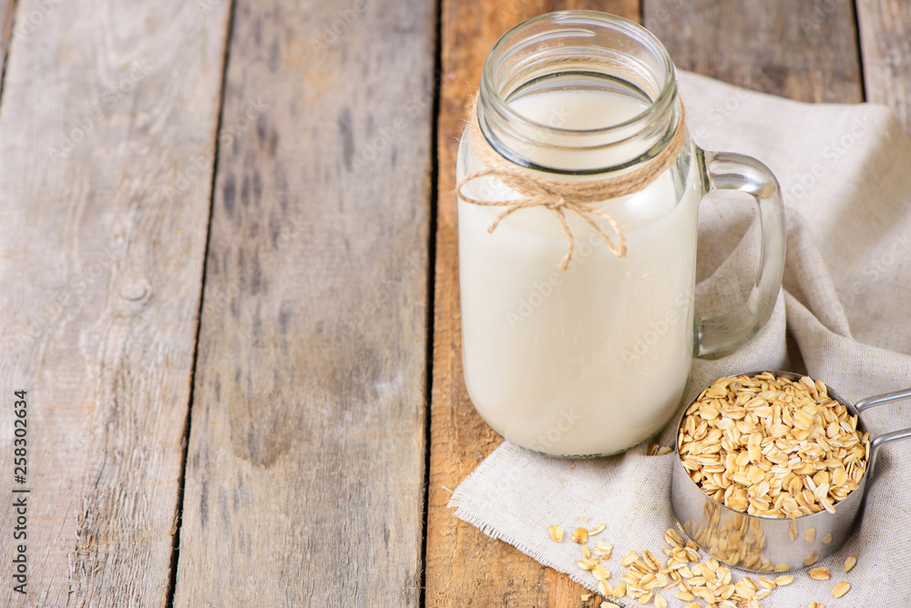 Vegan non dairy oat milk in a jar with copy space Vegan non dairy oat milk in a jar with copy space