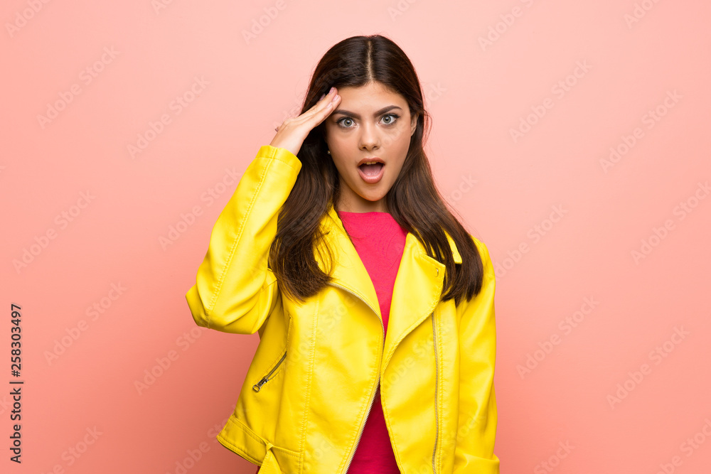 Teenager girl over pink wall has just realized something and has intending the solution Teenager girl over pink wall has just realized something and has intending the solution