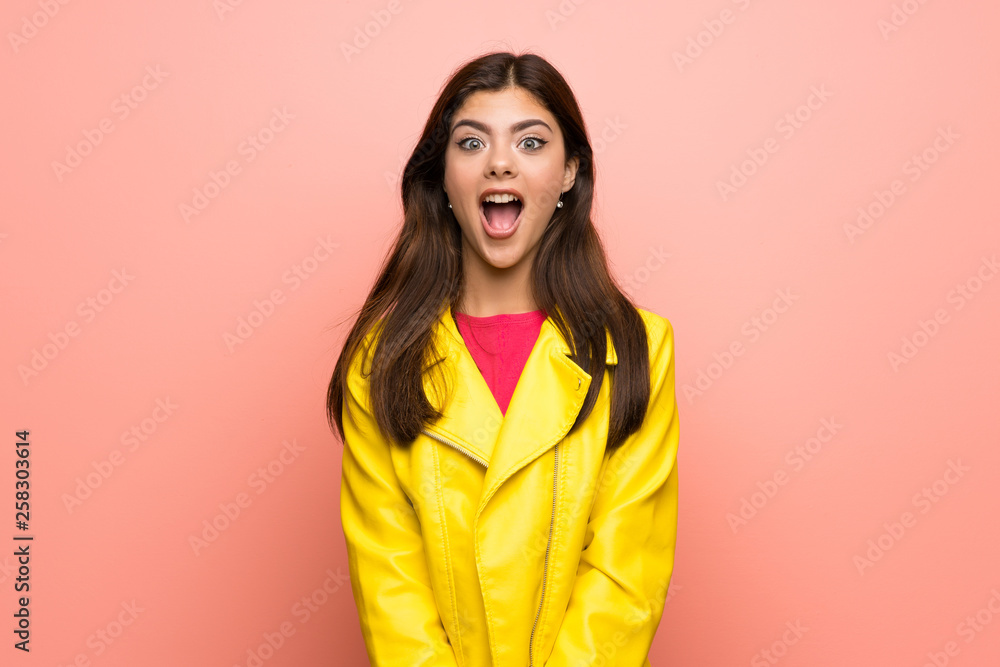 Teenager girl over pink wall with surprise facial expression Teenager girl over pink wall with surprise facial expression